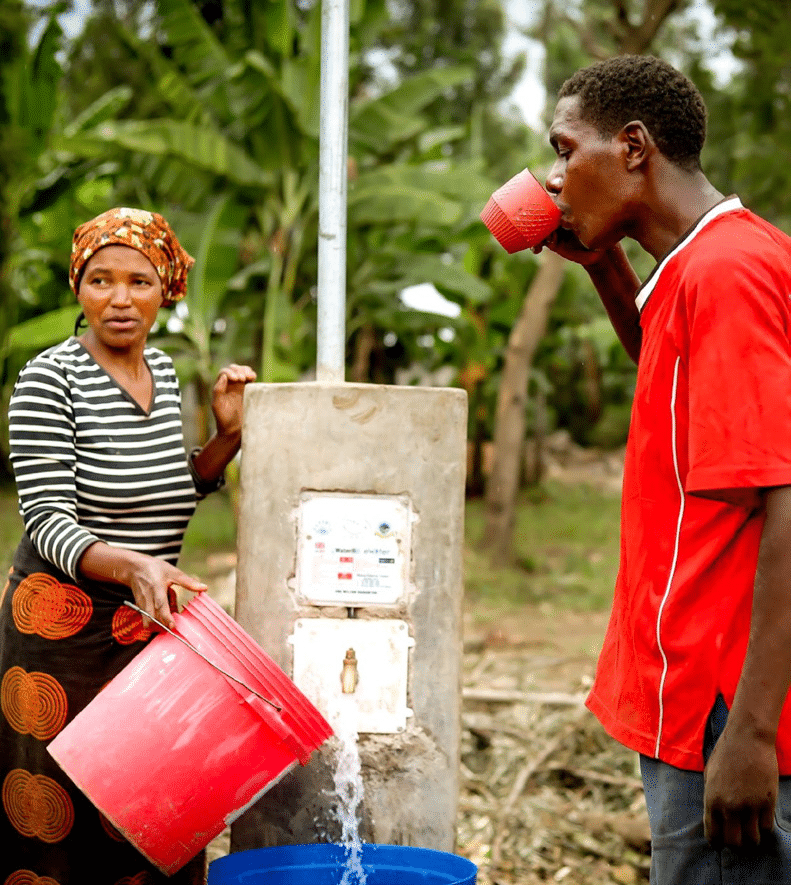 Two people drinking from tap powered by solar energy