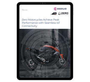 A tablet displays a document featuring a side view of a red and black Zero motorcycle, highlighting how Zero Motorcycles achieve peak performance with seamless IoT for Automotive connectivity, alongside Eseye and Zero Motorcycles logos.